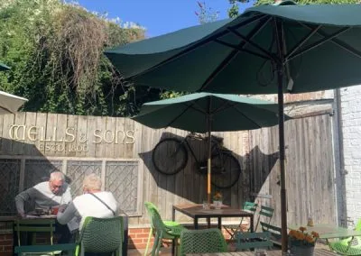 Patio garden tables under a green parasol